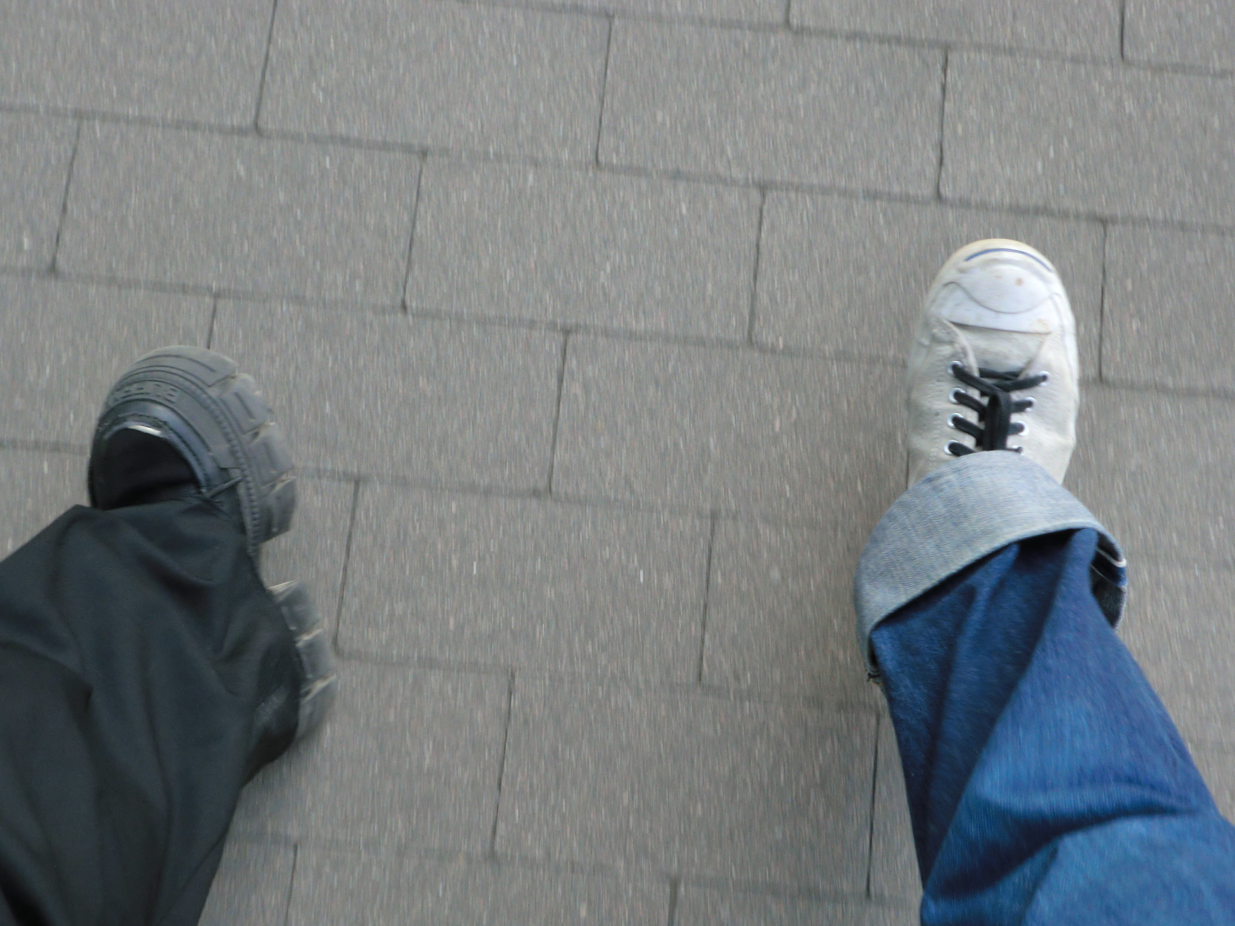 two legs by two people seen while walking 4